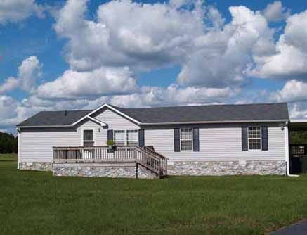 A mobile home on a grassy lot